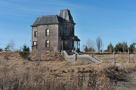 brown concrete 2-story house under blue sky at daytime thumbnail