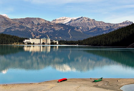 two red and green kayaks near calm body of water thumbnail