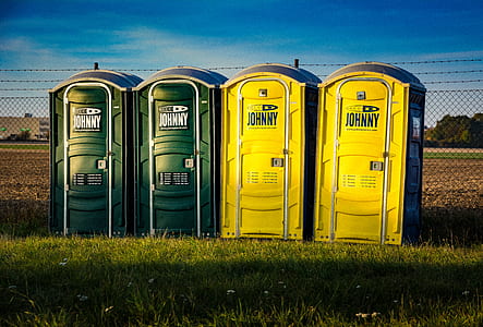 four green-and-blue Johnny portable toilet thumbnail