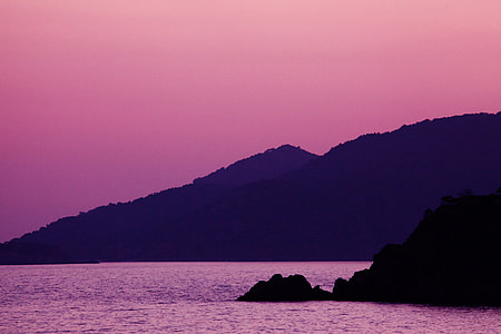 body of water beside mountain during golden hour thumbnail
