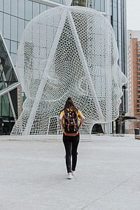 woman wearing yellow top and backpack thumbnail