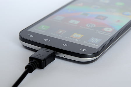 black smartphone with black cord connected thumbnail