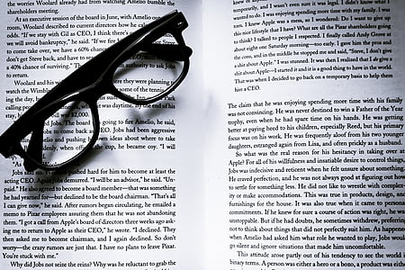 black framed eyeglasses on opened book thumbnail