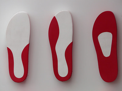 three white-and-red shoe soles on white surface thumbnail
