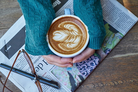 person holding cappuccino in mug thumbnail