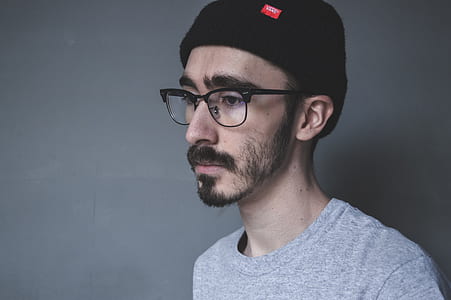 man wearing gray crew-neck shirt and black frame eyeglasses thumbnail