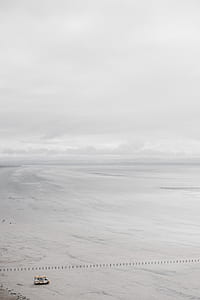 bird's eye view photography of white vehicle near seashore thumbnail
