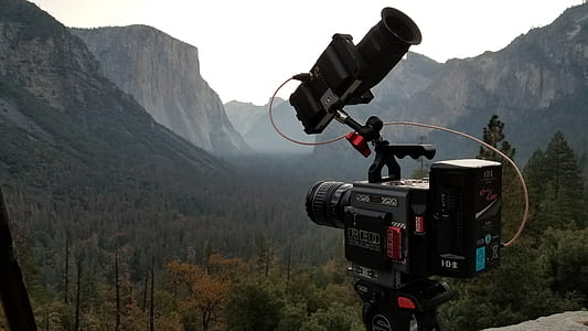 black video recorder pointing on green mountain thumbnail