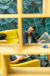 man sitting on yellow sofa thumbnail