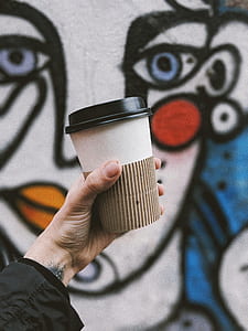 person holding disposable cup thumbnail