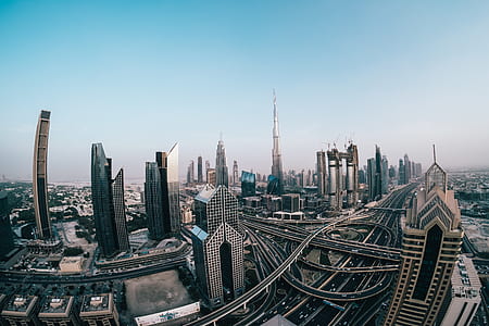gray and brown city buildings under blue sky photography thumbnail