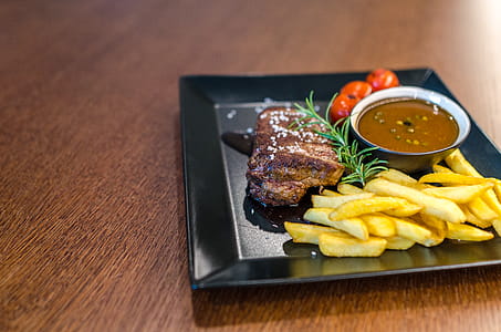 Grilled Beef With Fries and Sauce on Black Ceramic Plate thumbnail
