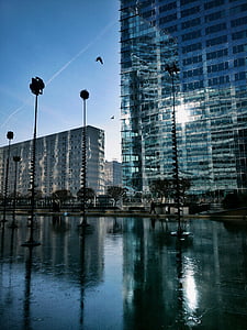 photo of post near clear building under blue sky at daytime thumbnail