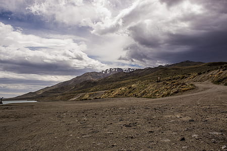 Photography of Mountains Under Cloudy Sky thumbnail