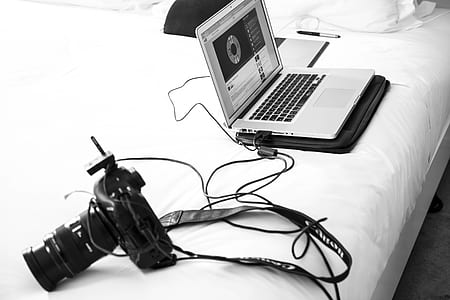 DSLR camera beside laptop thumbnail