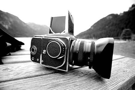 grayscale photo of professional video camera on table thumbnail