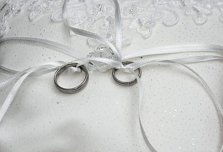 two silver-colored rings tied with white ribbons thumbnail