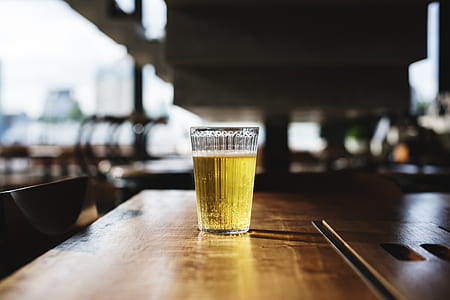 clear drinking glass filled with yellow liquid thumbnail