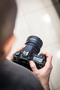 person holding black DSLR camera thumbnail
