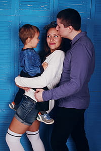 family of three behind louver door photo thumbnail