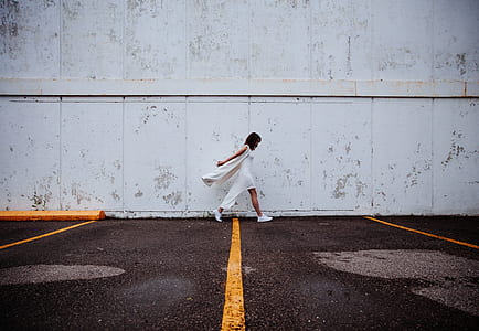 woman wearing side-slit dress near the wall graphic wallpaper thumbnail