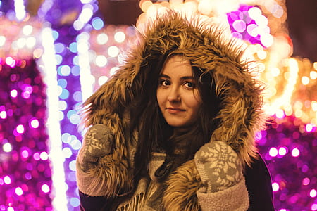 woman holding hood of jacket thumbnail