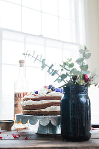 3-layer chocolate cake on tray beside black glass jar thumbnail