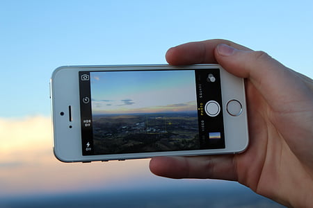person holding iPhone 5s thumbnail
