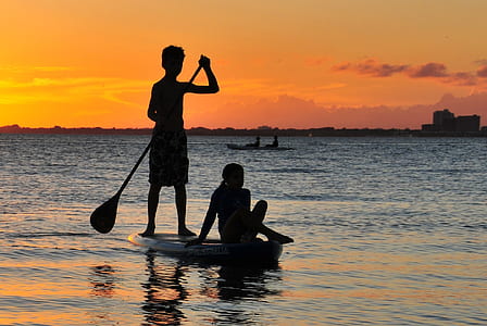 silhouette of man rowing boat thumbnail