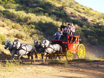 people in red horse carriage at daytime thumbnail