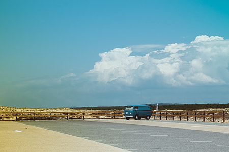blue van on parking area during daytime thumbnail