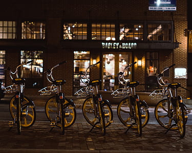 five parked black and white city bicycles thumbnail