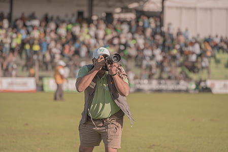 person standing holding camera with people thumbnail