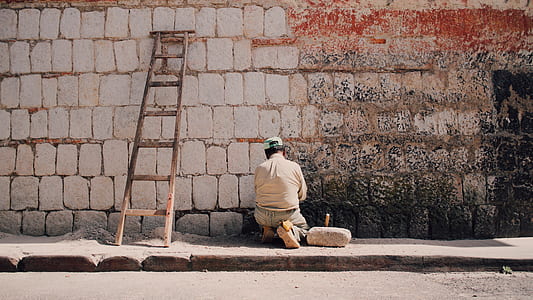 man sitting near wooden ladder thumbnail