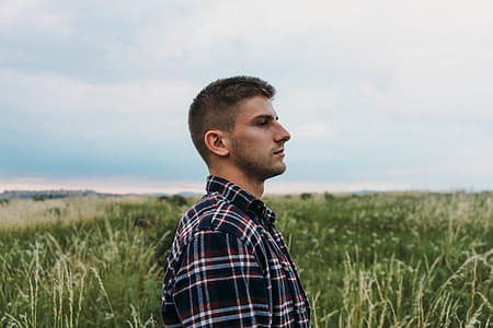 Man Standing on Grass Field thumbnail