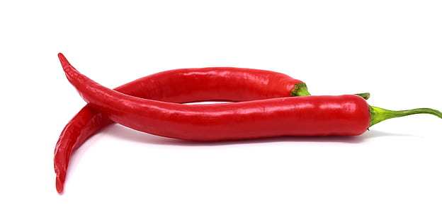two red chilies on white surface thumbnail