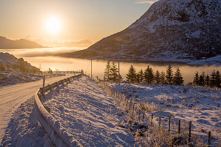 snow covered road overlooking sunset thumbnail