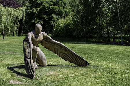 angle gray statue on green grass during daytime thumbnail