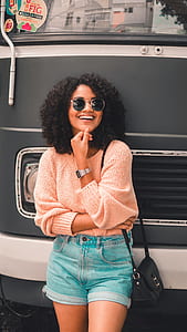 woman standing in front of black and white vehicle thumbnail
