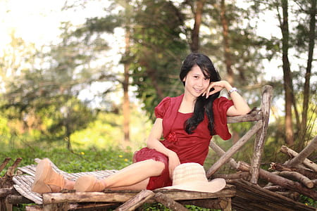 girl wearing red dress near trees thumbnail