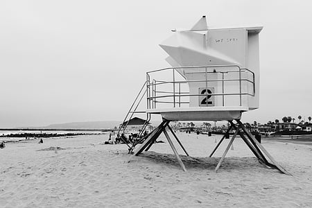 grayscale photo of lifeguard station on beach thumbnail
