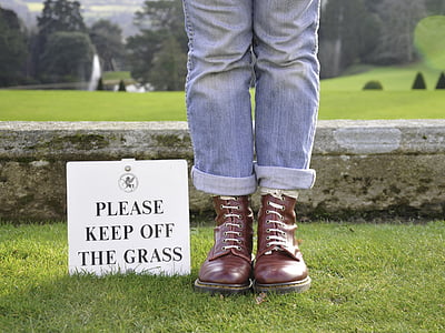 person in blue jeans and brown leather boots thumbnail