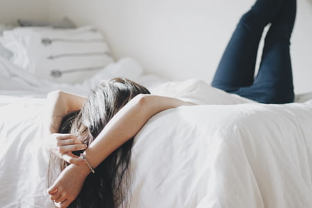 woman in white shirt laying on bed thumbnail