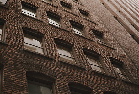 low angle photography of brown concrete building thumbnail