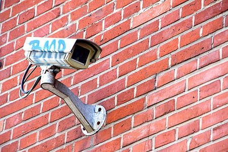 white surveillance camera on wall during daytime thumbnail