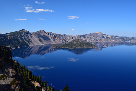 landscape photography of mountains near body of water thumbnail