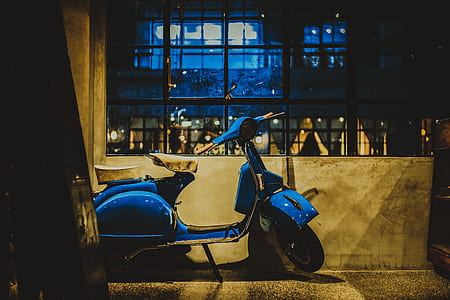 blue motor scooter beside wall thumbnail