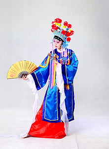 woman wearing blue, white, and red traditional coat thumbnail