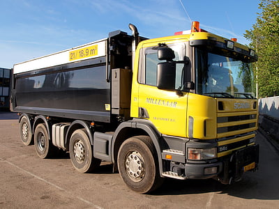 yellow and black garbage truck during daytime thumbnail