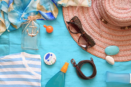flat lay photography of sunglasses, belt, bottle, and soap thumbnail